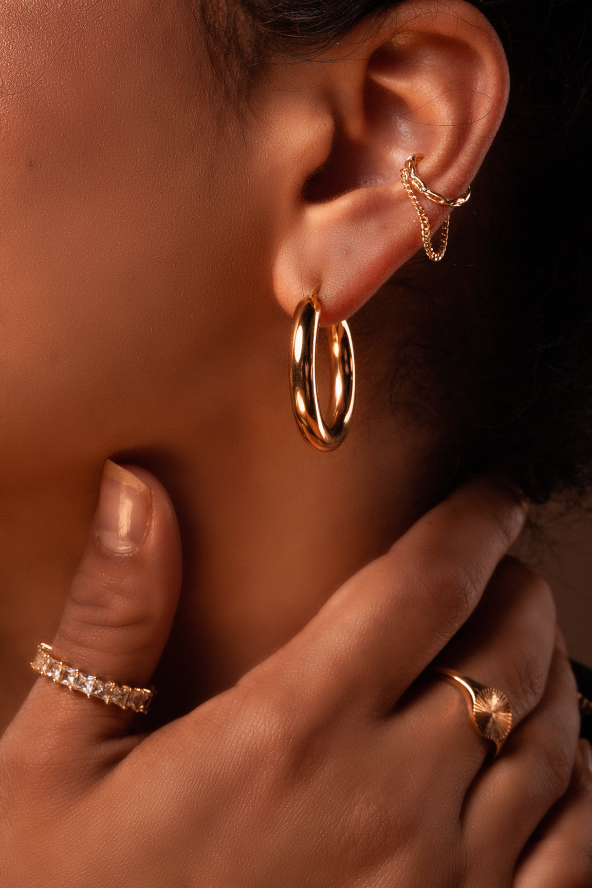 Woman flaunting her elegant style wearing Classic Gold Hoop Earrings, 18K gold-plated and hypoallergenic, perfect for a chic fashion statement. B-Xquisite Jewelry Earrings