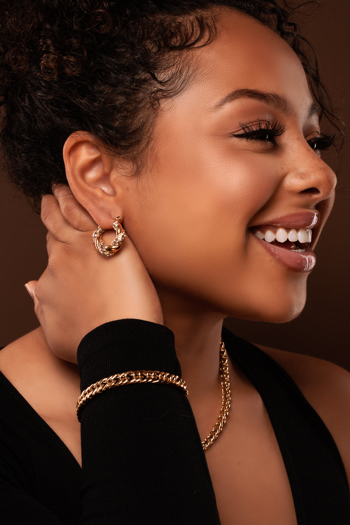 Full view Natalia Hoop earrings. Gold plated stainless steel, with twisted pave' cubic zirconia stones.